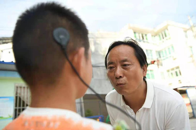 赵小平在给听障儿童做发音练习