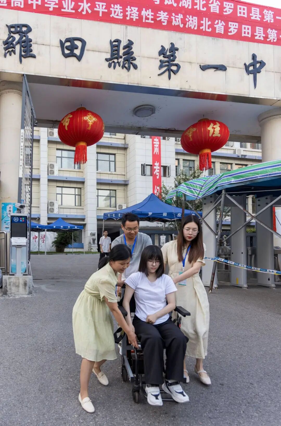 图为曹慧婷在妈妈张胜兰(左)、班主任熊晟(后)和送考老师的帮助下,坐着轮椅“走”出考场 图为曹慧婷在妈妈张胜兰(左)、班主任熊晟(后)和送考老师的帮助下,坐着轮椅“走”出考场